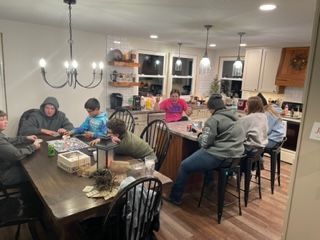 A small church gathering sharing conversation around a table